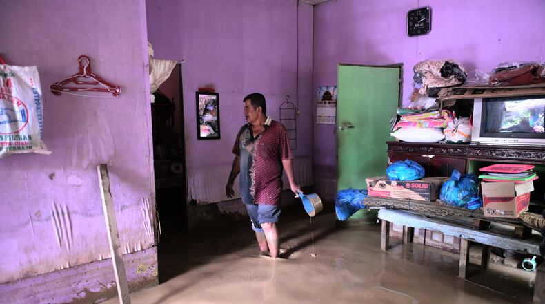 A man stands inside his flooded home in Pidie Jaya, Aceh province, Indonesia, Wednesday, Dec. 3, 2025. (AP Photo/Reza Saifullah)