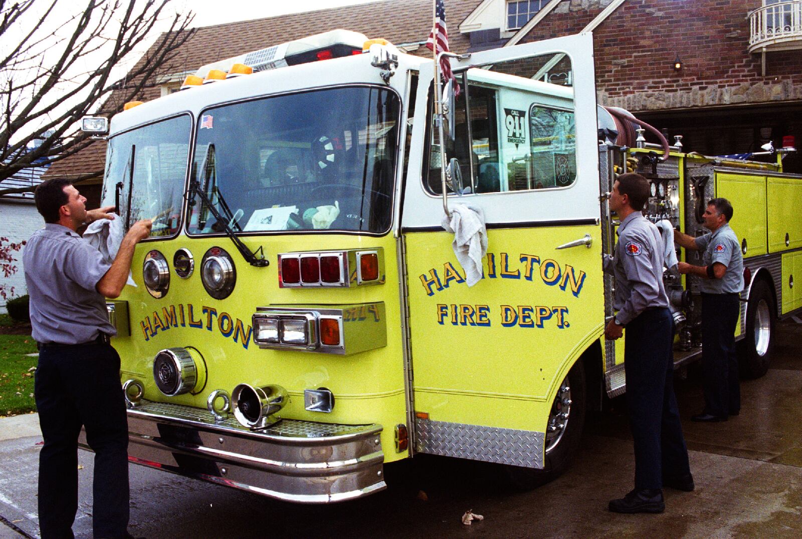 Greg Lynch/Journal-News
John Hansbauer, Dave Storck, and Shawn Pater of Hamilton's Fire Station #4, wash their firetruck on "Truck Day", Thursday.  Though the truck is cleaned daily, once a week a more extensive cleaning is performed.