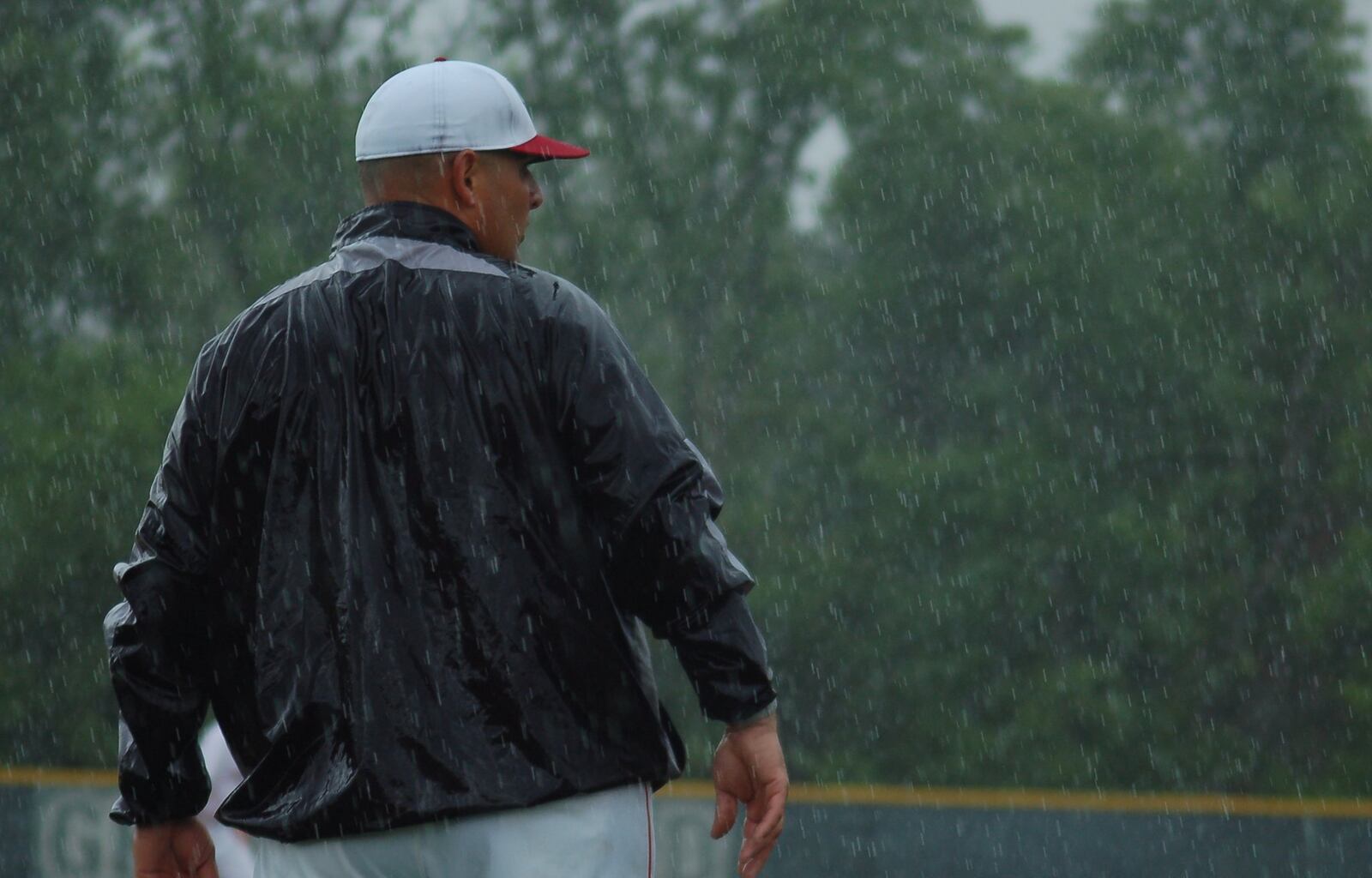 Carlisle’s Chris Hawkins does some coaching in the rain Thursday during a Division III regional semifinal against Cincinnati Country Day at the Athletes in Action complex in Xenia. CONTRIBUTED PHOTO BY JOHN CUMMINGS