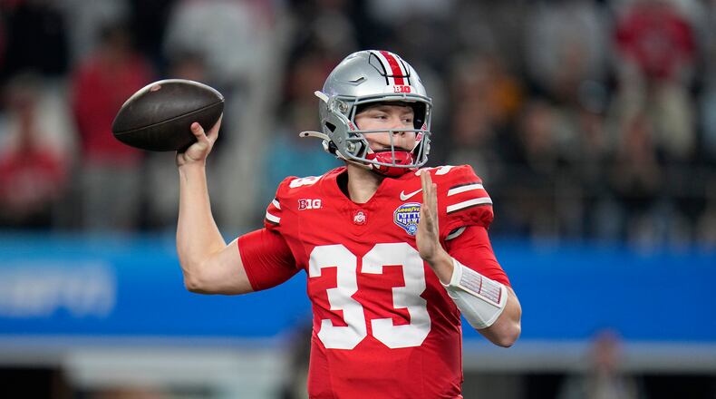 Ohio State quarterback Devin Brown throws a pass against Missouri during the first half of the Cotton Bowl NCAA college football game Friday, Dec. 29, 2023, in Arlington, Texas. (AP Photo/Julio Cortez)