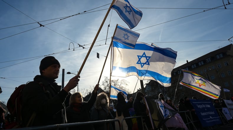 Participants gather hold up Israeli flags during a demonstration in Leipzig, Germany, Saturday, Jan. 17, 2026. (Heiko Rebsch/dpa via AP)