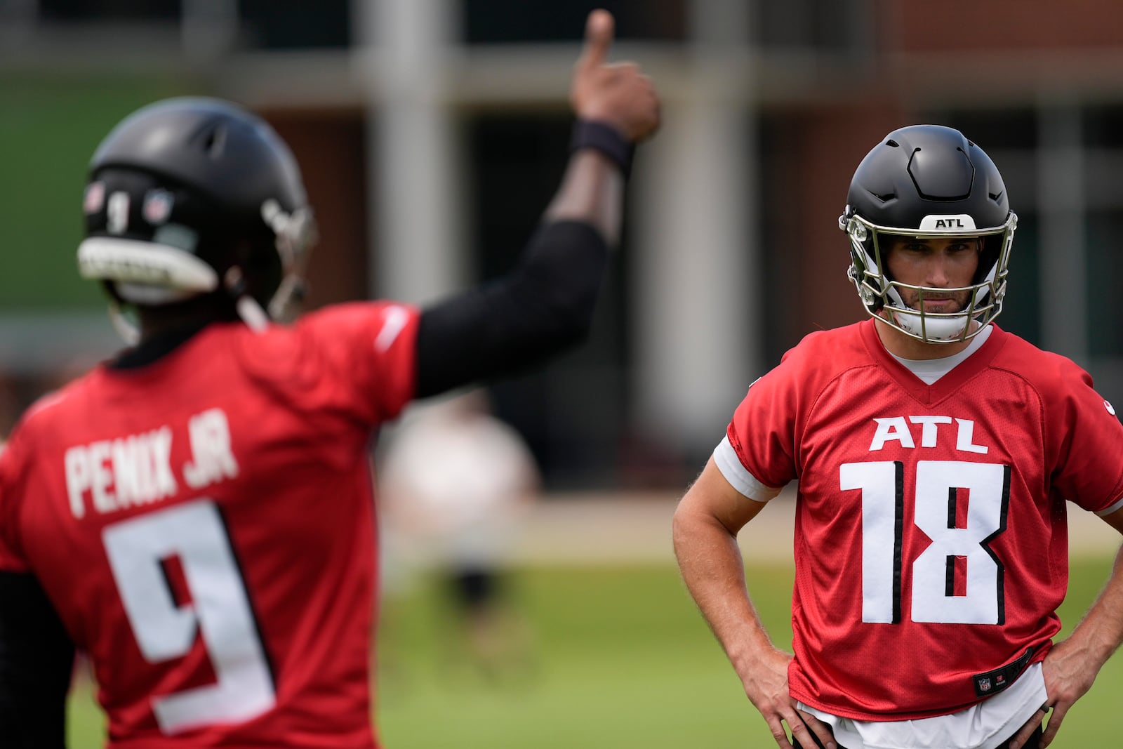 Atlanta Falcons quarterback Kirk Cousins, right, and quarterback Michael Penix Jr., work out during practice at NFL football minicamp, Tuesday, June 10, 2025, in Flowery Branch, Ga. (AP Photo/Mike Stewart)