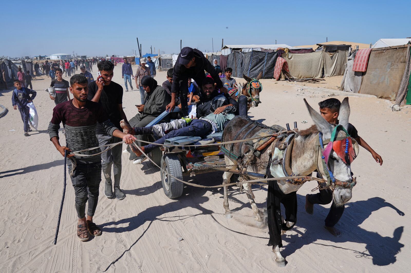 Palestinians carry an injured man after he was shot at an aid distribution center run by the Gaza Humanitarian Foundation a U.S.-backed organization approved by Israel in Khan Younis, southern Gaza Strip, on Thursday, May 29, 2025. (AP Photo/Abdel Kareem Hana)