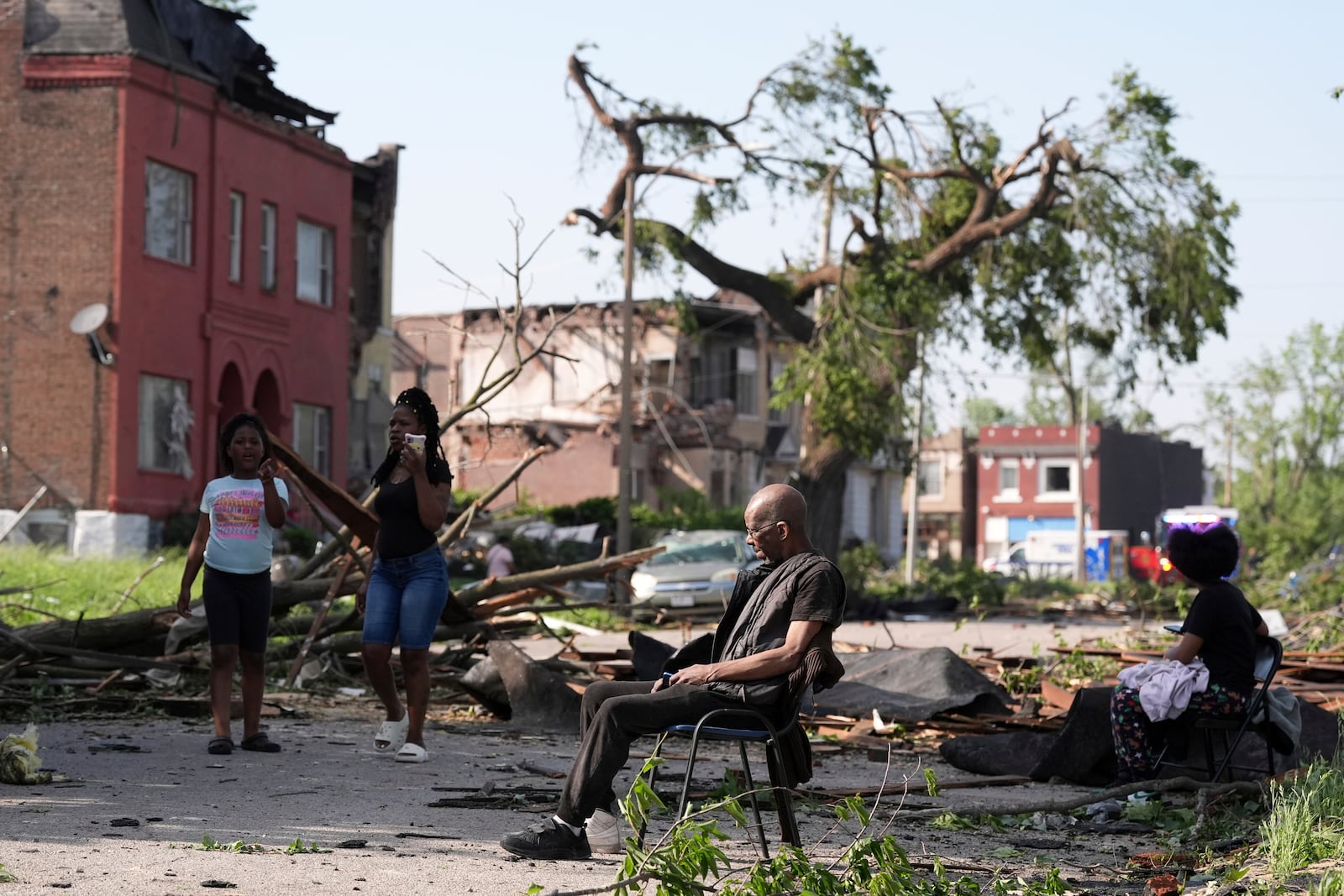 A man sits in a chair after a severe storm moved through St. Louis, Missouri, Friday, May 16, 2025. (AP Photo/Jeff Roberson)