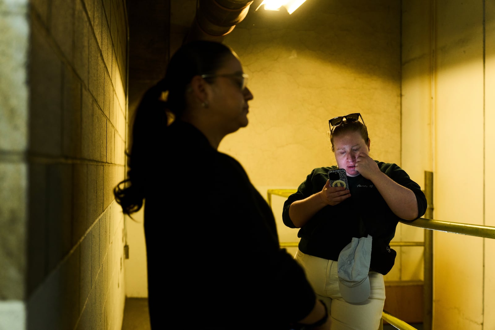 U.S. citizen Christina Jimenez, right, waits for news about her step father originally from Guatemala, who was detained by federal agents, outside the ICE Los Angeles Staging Facility in Los Angeles, on Wednesday, June 25, 2025. (AP Photo/Damian Dovarganes)