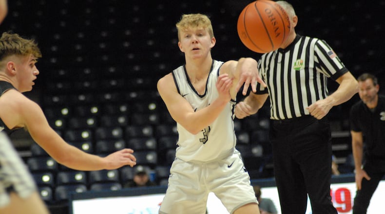 Lakota East’s Luke Adkins (3) makes a pass against Covington Catholic on Sunday night in the Holiday Hardwood Classic at Xavier University’s Cintas Center. Chris Vogt/CONTRIBUTED