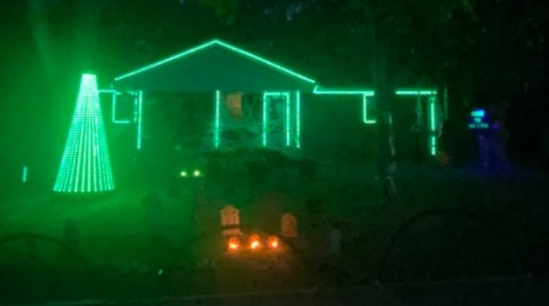 The Gardner home on Miami Western Drive in Oxford is complete with more than 2,500 individual pixels of light, backed by a fog machine flowing over a row of tombstones, and is flanked by a set of inflatable Halloween characters. TAJ SIMMONS/CONTRIBUTED