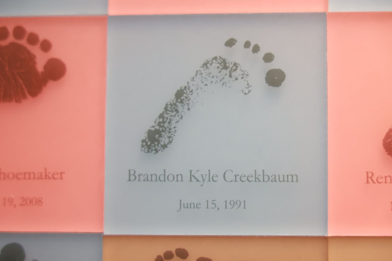 A tile featuring Brandon Creekbaum’s newborn footprint from 1991 is displayed on the Baby’s Footprint Wall in the Berry Women’s Center at Miami Valley Hospital. PHOTO BY WILL JONES/PREMIER HEALTH 