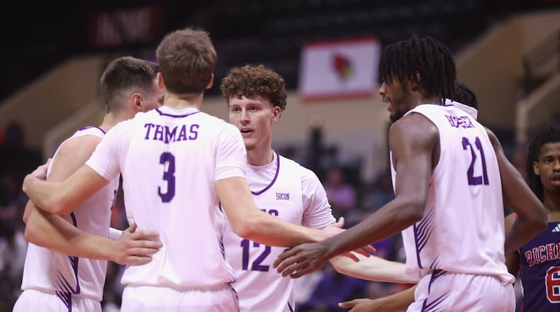 Centerville graduate Tom House, a senior at Furman, huddles with his teammates during a game against Richmond in the first round of the ESPN Events Invitational on Thursday, Nov. 27, 2025, at the State Farm Field House in Kissimmee, Fla. David Jablonski/Staff