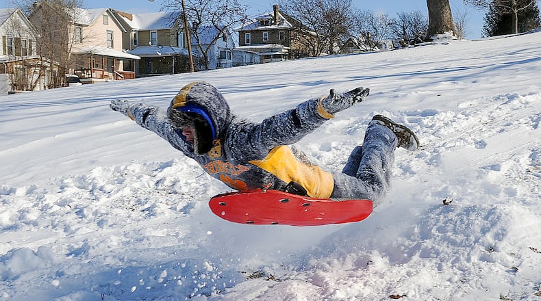 Adrian Jaynes, 15, flies in the air sledding down the hill at Standpipe Park. MARSHALL GORBY / STAFF