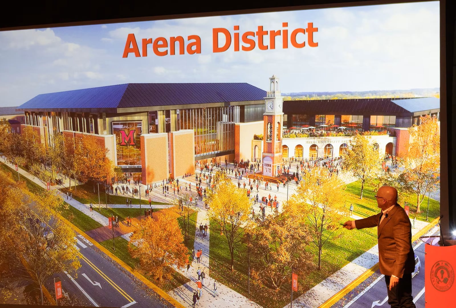 Miami officials are growing closer to approval of converting its main campus recreational field into an “Arena District” that will see the current Cook Field become the site of the school’s new sports arena, adjacent hotel and other facilities as Millett Hall is eventually closed down. Pictured is Miami University President Gregory Crawford earlier this year unveiling a possible design for the new sports arena. (File)