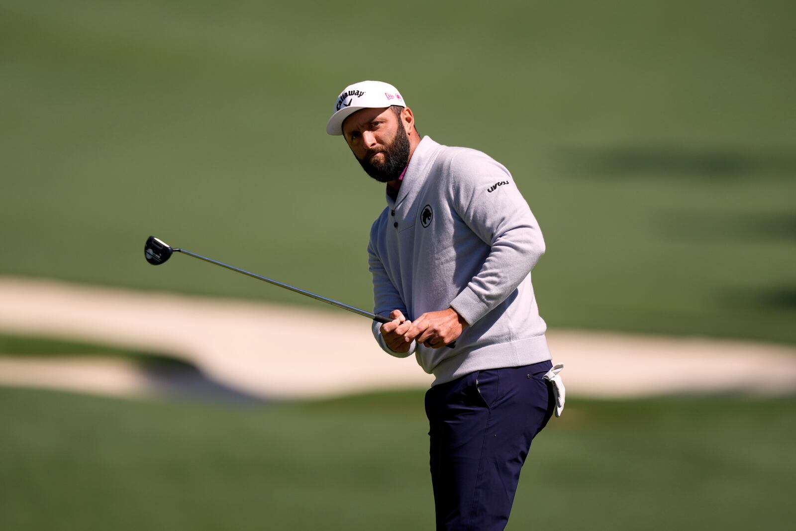 Jon Rahm, of Spain, chips onto the 10th green during a practice round at the Masters golf tournament, Tuesday, April 8, 2025, in Augusta, Ga. (AP Photo/Matt Slocum)