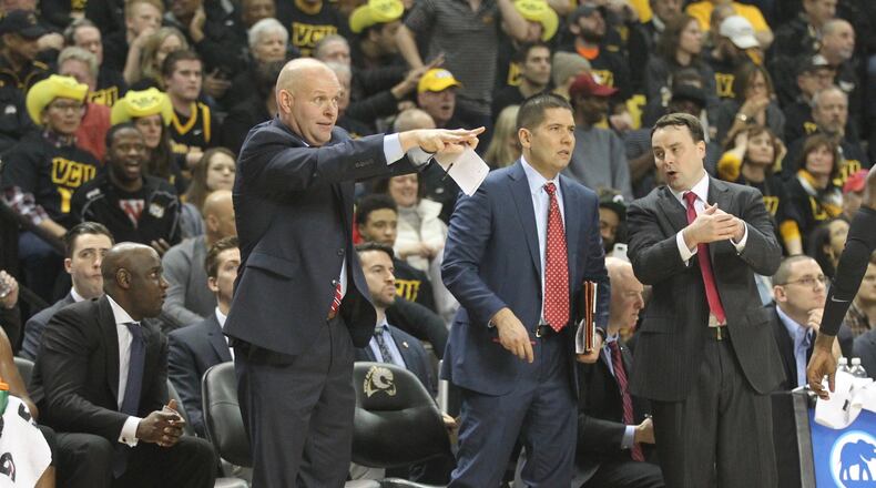 Dayton’s Allen Griffin, Kevin Kuwik, Tom Ostrom and Archie Miller coach during a game against Virginia Commonwealth on Friday, Jan. 27, 2017, at UD Arena. David Jablonski/Staff
