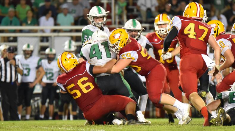 Fenwick’s Sam Secrest (56) and Leo Bell (59) bring down Badin’s Ethan Wishart (41) during last Friday’s game at Krusling Field in Middletown. Host Fenwick won 21-9. CONTRIBUTED PHOTO BY ANGIE MOHRHAUS