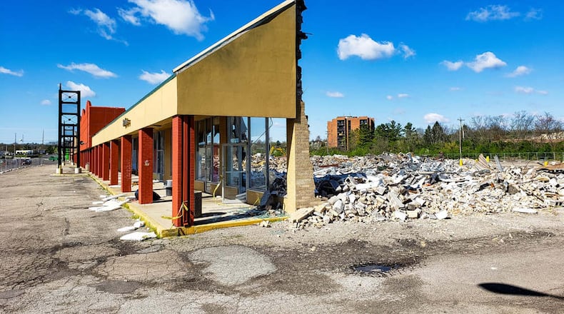 Workers from Construction Design Management, based in Bowling Green, Ky., are demolishing most of the Hamilton West Shopping Center and building an 85,000-square-foot indoor, climate-controlled, self-enclosed store unit, occupying 5.7 acres, said Matt Williams, one of the four partners. NICK GRAHAM / STAFF