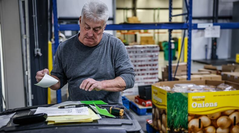 FoodBank employee, Tom Derringer unloads a truck with food from Sam's Club Wednesday March 1, 2023 at the warehouse on Armor Place in Dayton. JIM NOELKER/STAFF
