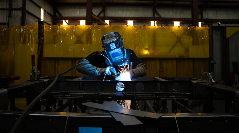 A welder is seen inside the Allen Engineering Corporation plant Monday, March 16, 2026, in Paragould, Ark. (AP Photo/Kevin Wurm)