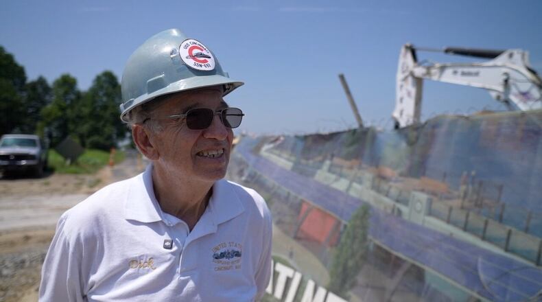 Dick Young, a submarine veteran, stands outside the construction site of the USS Cincinnati memorial. Young served in the Navy and spent time in a submarine like just like it. He went on to become a 911 supervisor and dispatcher here for 44 years. PHOTO BY MARC PRICE