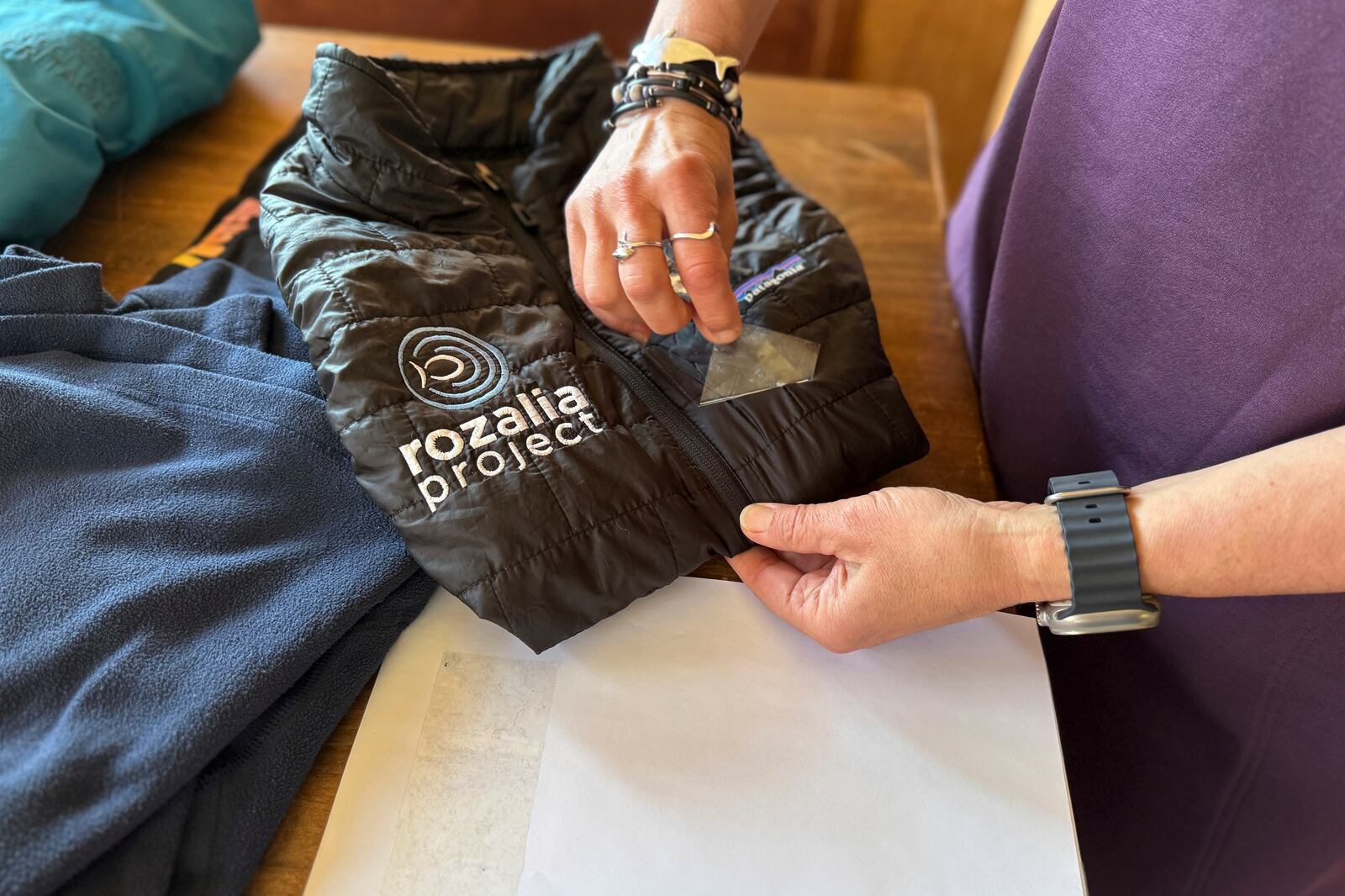 Rachael Z. Miller, founder of the Vermont-based Rozalia Project for a Clean Ocean, conducts a tape test on various clothing items to compare how much each material sheds microfibers on Thursday, April 17, 2025, in Granville, Vt. (AP Photo/Amanda Swinhart)