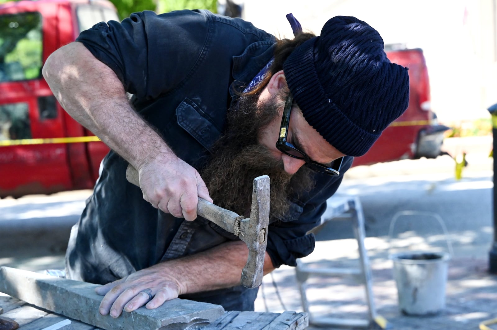 Devin Devine is a sculptor charged with creating a piece of art outside of the Well House Hotel in downtown Hamilton. It's the first piece commissioned by the City of Sculpture in a couple of years. Pictured is Devine working on the art installation on Oct. 9, 2025. MICHAEL D. PITMAN/STAFF