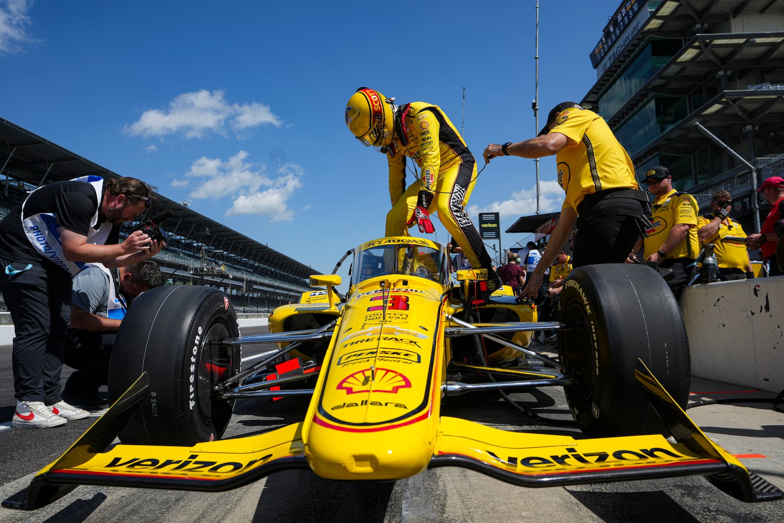 Scott McLaughlin, of New Zealand, climbs into his car during practice for the Indianapolis 500 auto race at Indianapolis Motor Speedway in Indianapolis, Friday, May 16, 2025. (AP Photo/Michael Conroy)