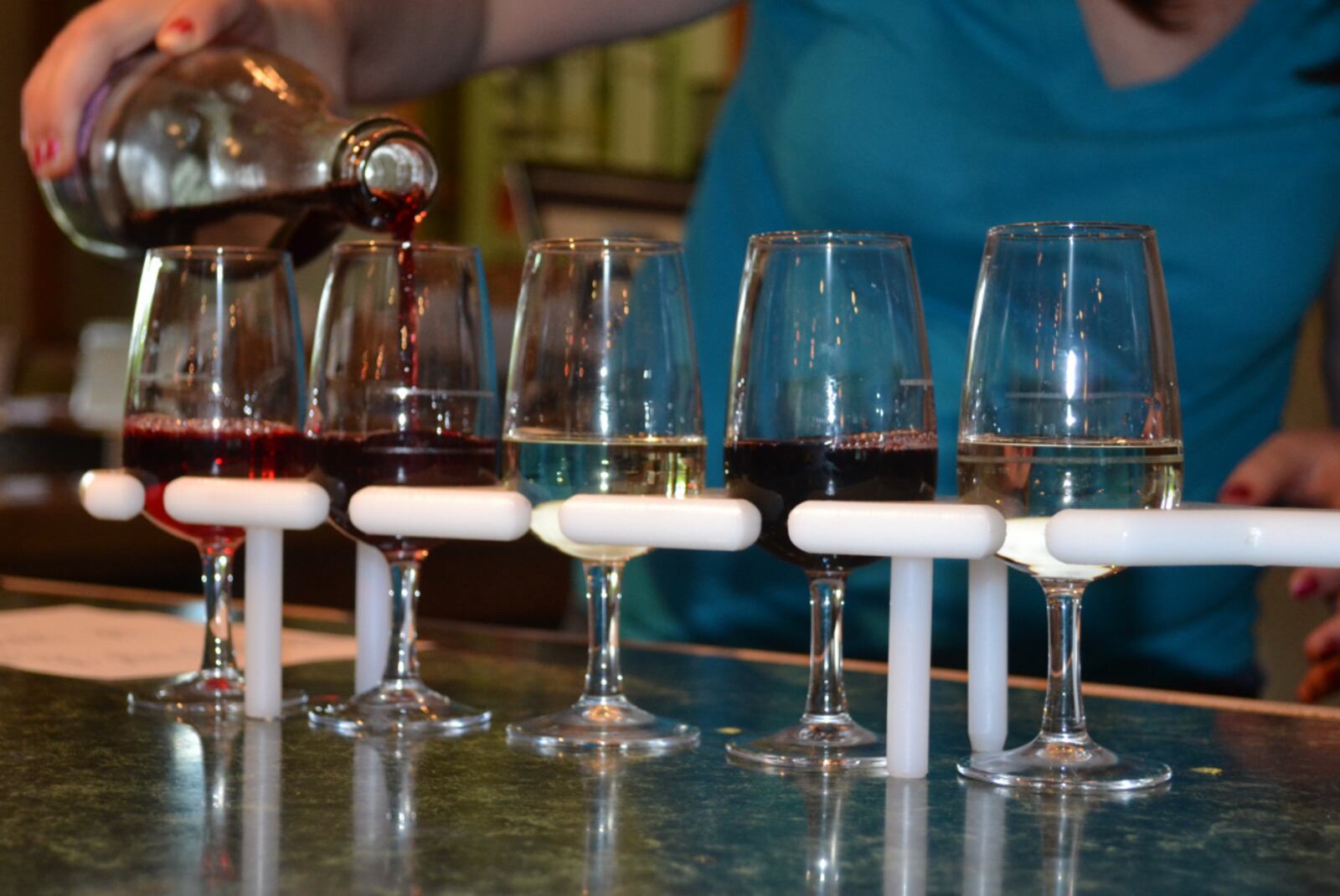 A "tasting paddle" of samples in the tasting room of the Winery at Versailles. Staff photo by Mark Fisher