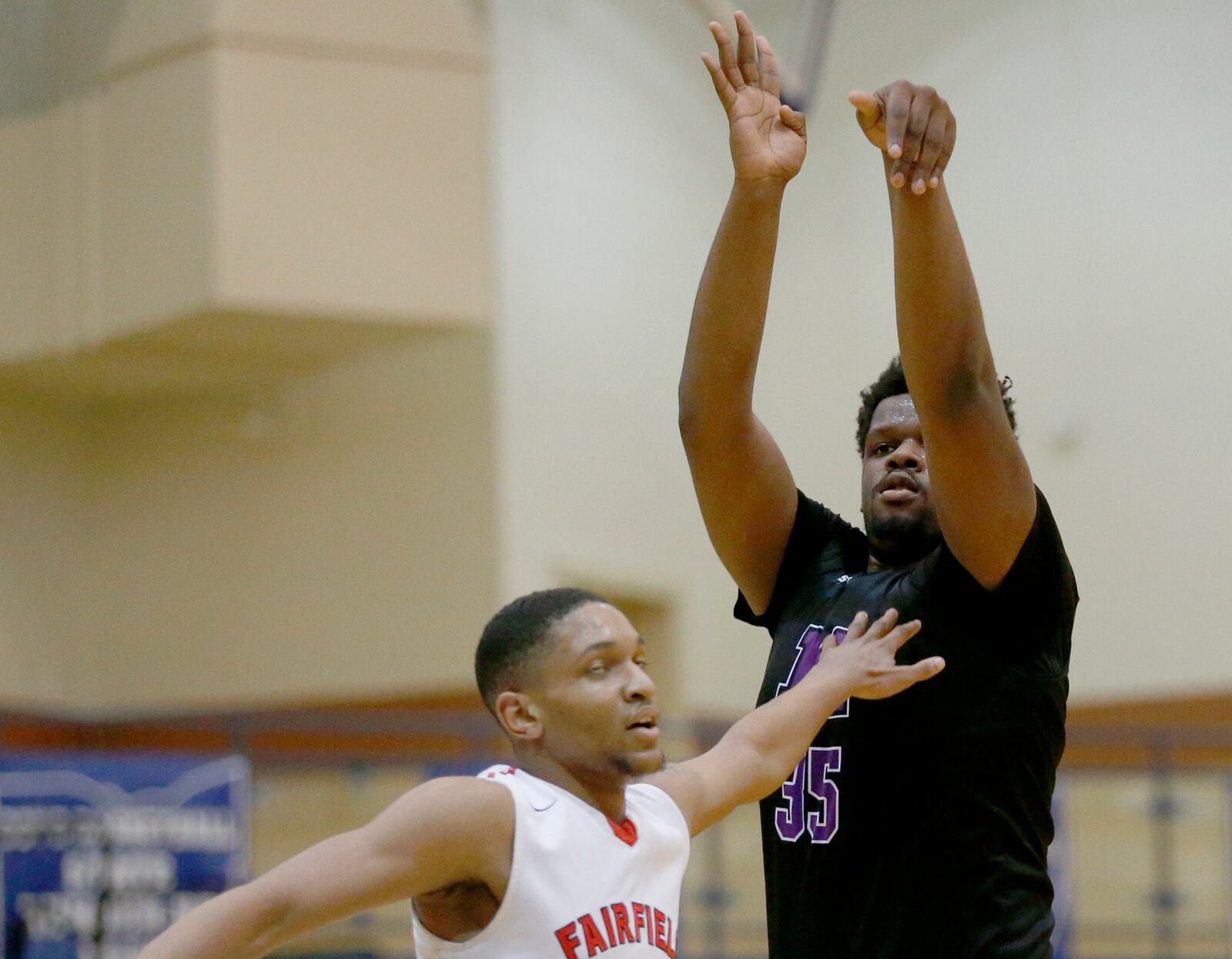 Middletown center E.J. Williams follows through on a shot over Fairfield forward Devin Turner during the All-Butler County All-Star boys basketball game at the Hamilton Athletic Center on Saturday night. CONTRIBUTED PHOTO BY E.L. HUBBARD