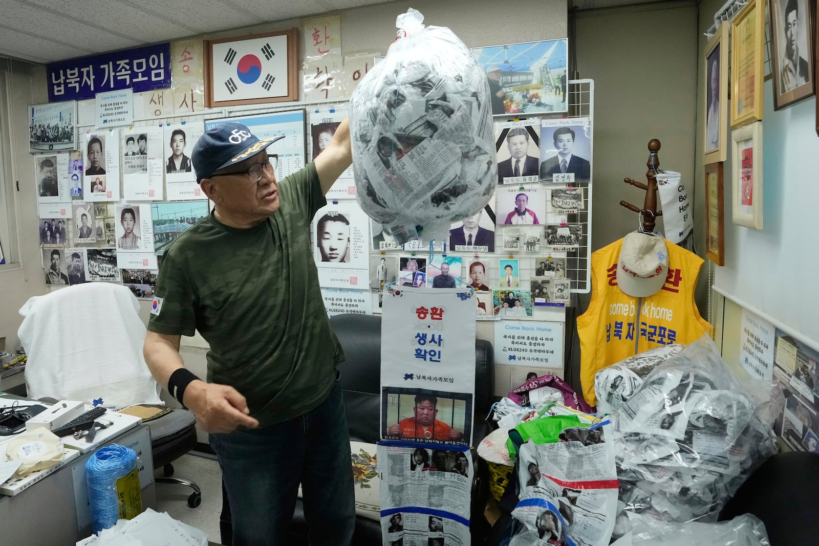 South Korean Choi Sung-Yong, a head of the Abductee's Family Union, holds a plastic bag containing leaflets during an interview with The Associated Press at his office in Seoul, South Korea, on June 14, 2025. (AP Photo/Ahn Young-joon)