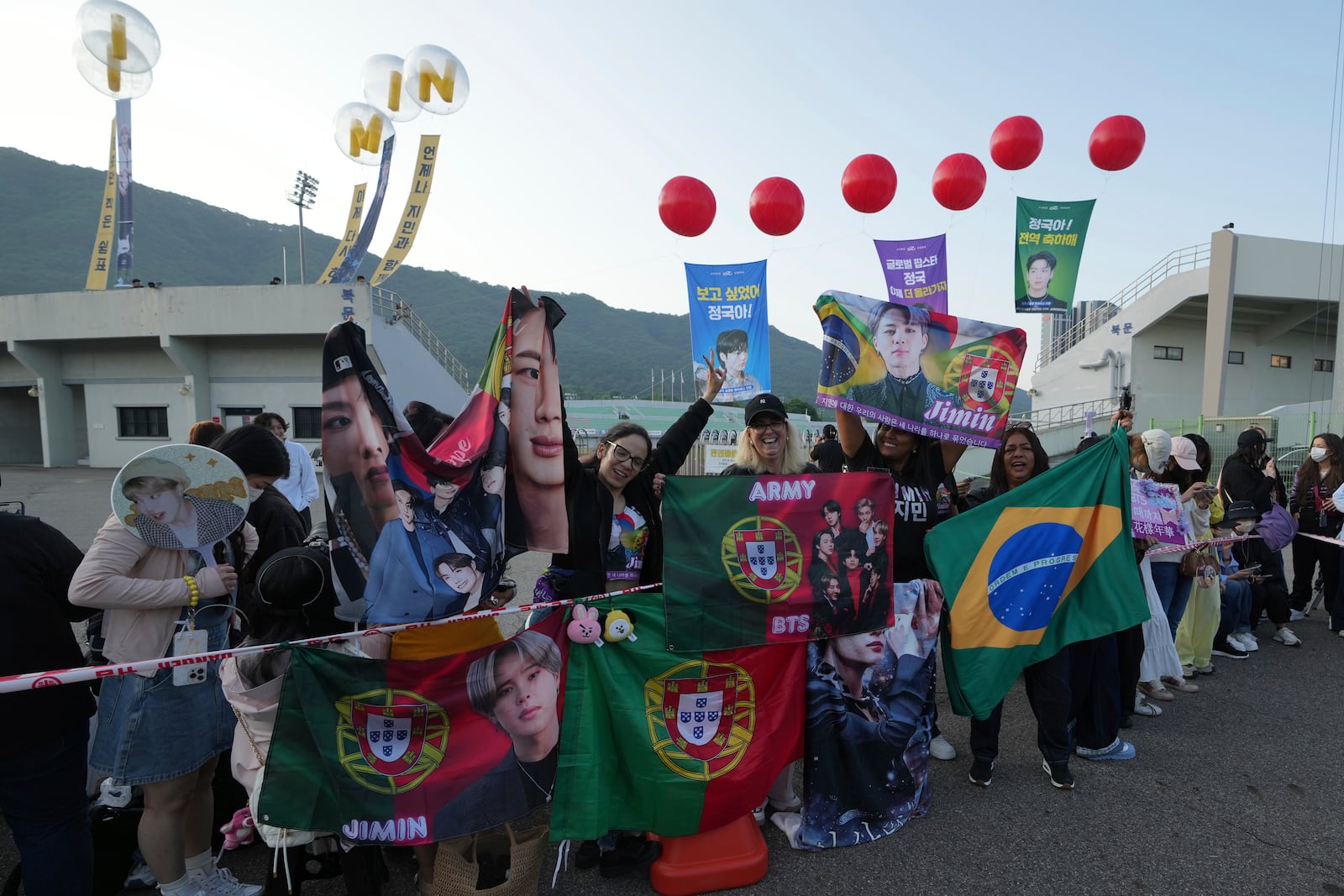Fans wait for arrival of K-pop band BTS members Jimin and Jung Kook in Yeoncheon, South Korea, Wednesday, June 11, 2025. (AP Photo/Lee Jin-man)
