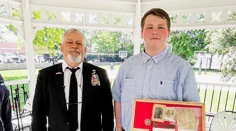 Seth Woodward, a Valley View High School senior, holds artifacts that once belonged to his great-great-great-geat grandfather who fought during the Civil War. Standing next to him is David Shortt, curator of the Veterans Memorial Museum Foundation in Germantown. SUBMITTED PHOTO