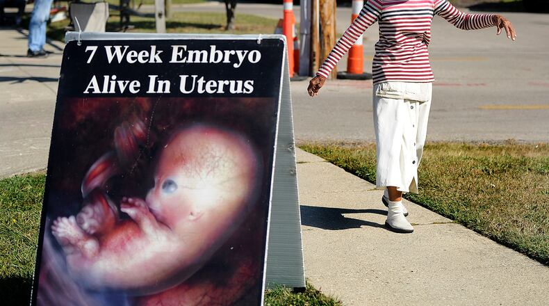 Vivian Skovgard, sings dances outside the Women's Med Center of Dayton, Tuesday, Oct. 3, 2023. MARSHALL GORBY\STAFF