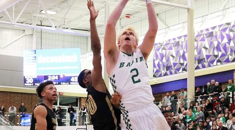 Badin’s Justin Pappas gets up a shot against Thurgood Marshall’s Anthony McComb (10) during Saturday night’s Division II district semifinal basketball game at Middletown’s Wade E. Miller Arena. Marshall won 67-53. CONTRIBUTED PHOTO BY TERRI ADAMS