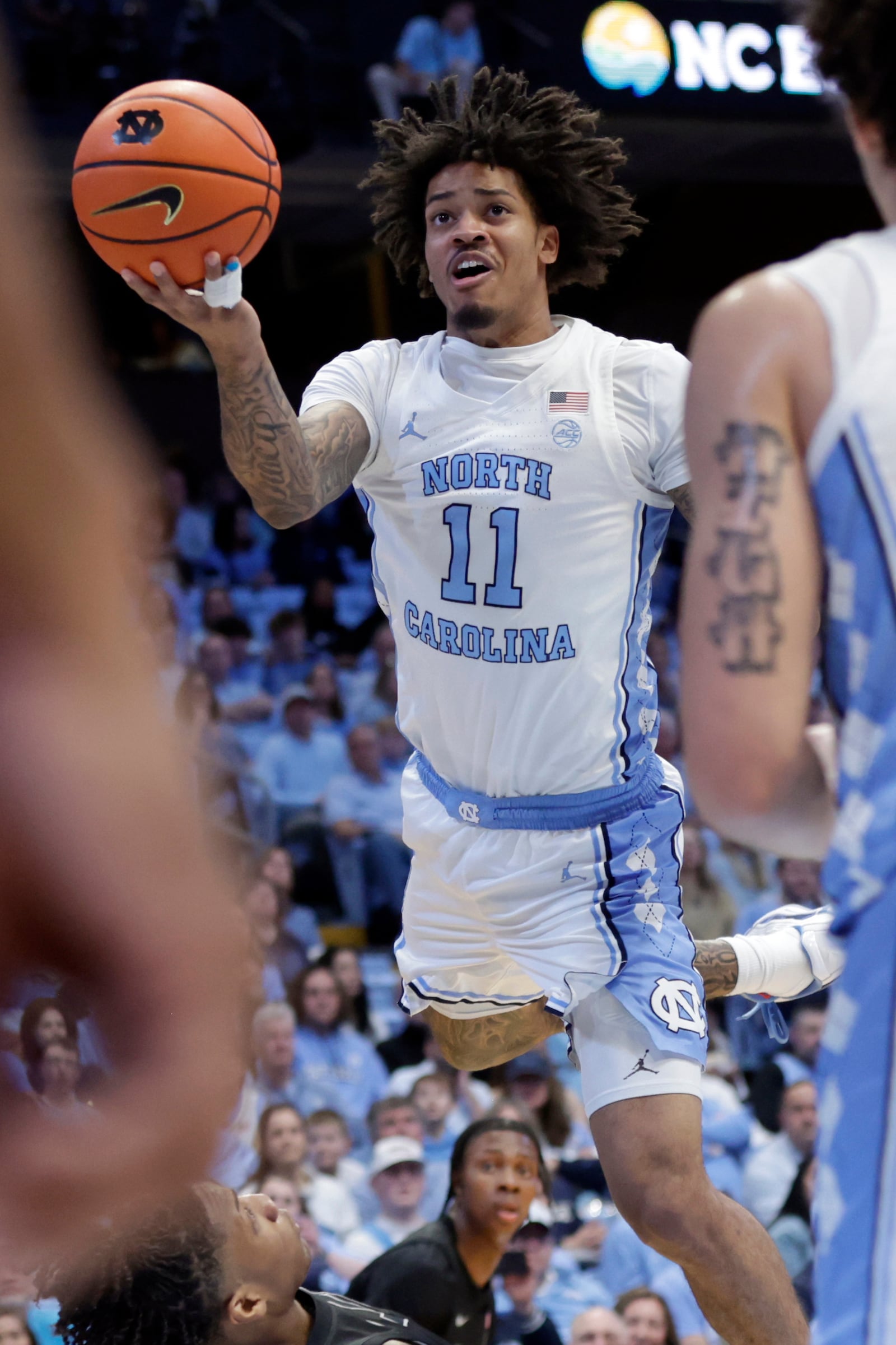 North Carolina forward Jonathan Powell (11) drives against Virginia Tech during the first half of an NCAA college basketball game Saturday, Feb. 28, 2026, in Chapel Hill, N.C. (AP Photo/Chris Seward)