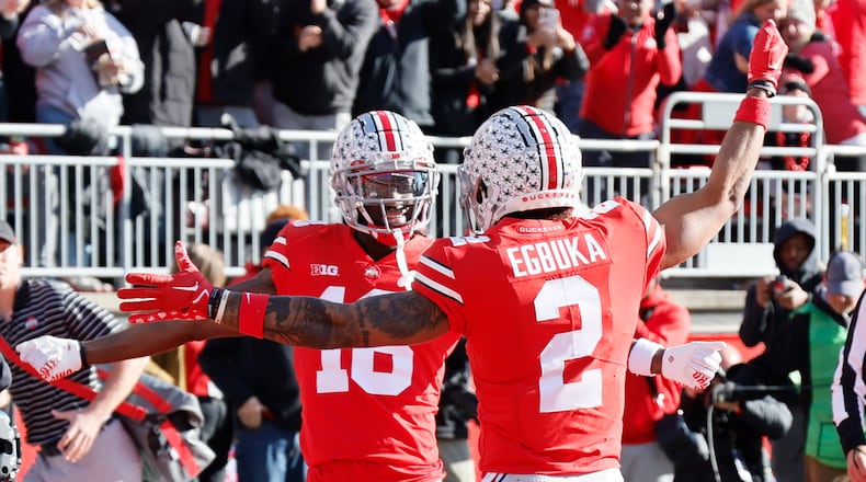 Ohio State receiver Marvin Harrison, left, celebrates his touchdown against Michigan with teammate Emeka Egbuka during the first half of an NCAA college football game on Saturday, Nov. 26, 2022, in Columbus, Ohio. (AP Photo/Jay LaPrete)