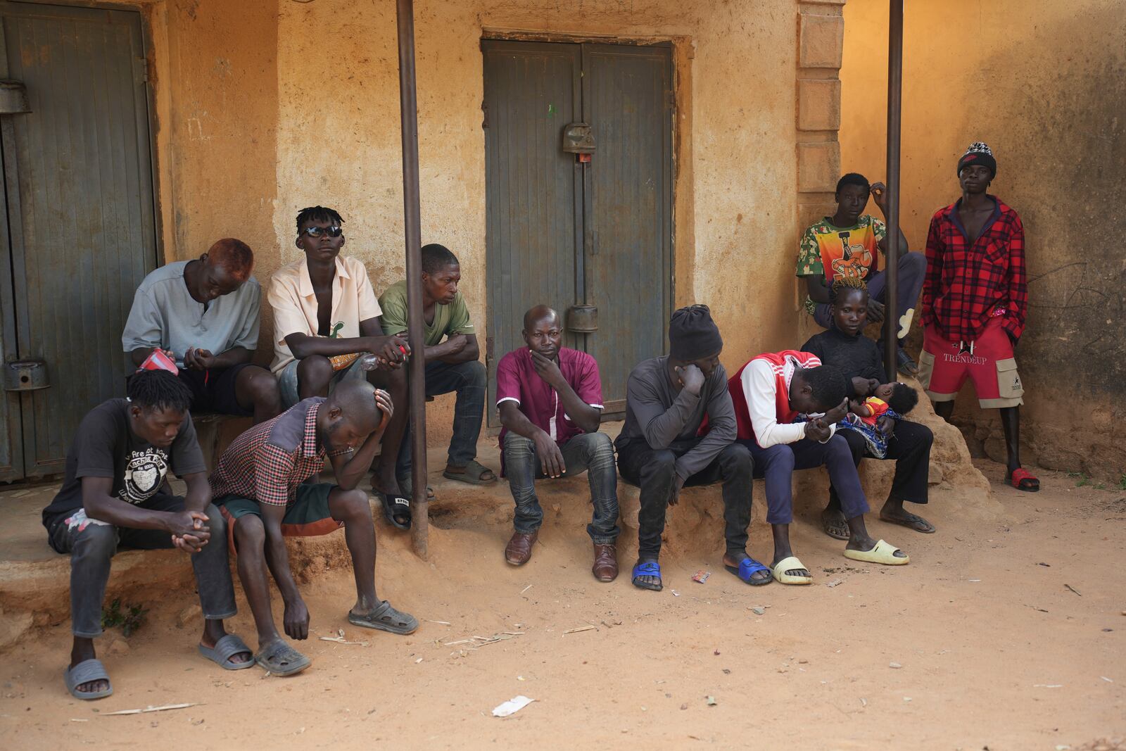 People mourn the death of a man following an attack by gunmen in the Zike farming community in north-central Nigeria, Tuesday, April 15, 2025. (AP Photo/Samson Omale)
