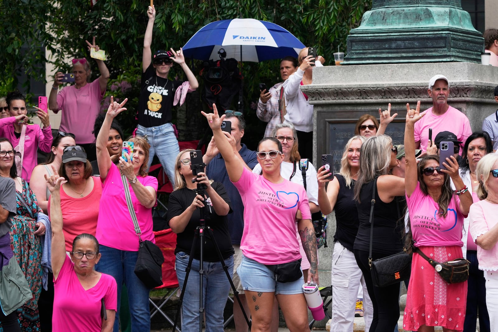 Supporters of Karen Read gesture as Read departs Norfolk Superior Court during jury deliberations at her trial, Tuesday, June 17, 2025, in Dedham, Mass. (AP Photo/Charles Krupa)