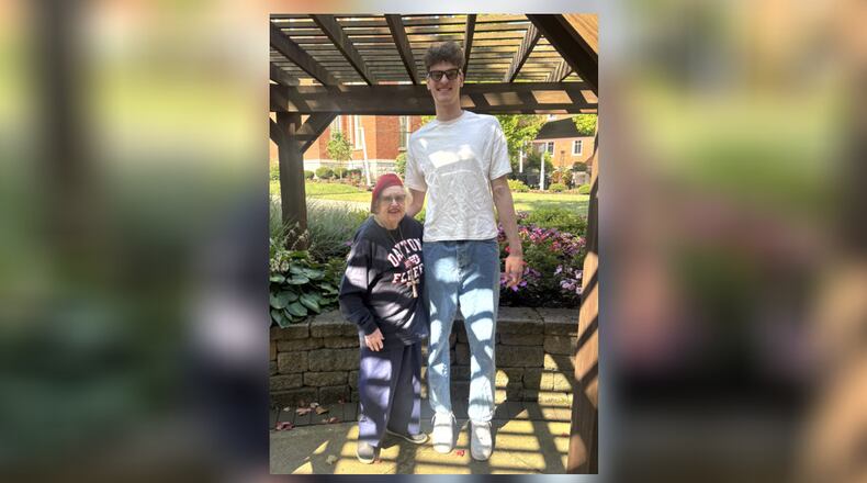 Dayton basketball fan Milly Hubler meets with Dayton's Amaël L'Etang at 10 Wilmington Place in Dayton in September 2025. Contributed photo