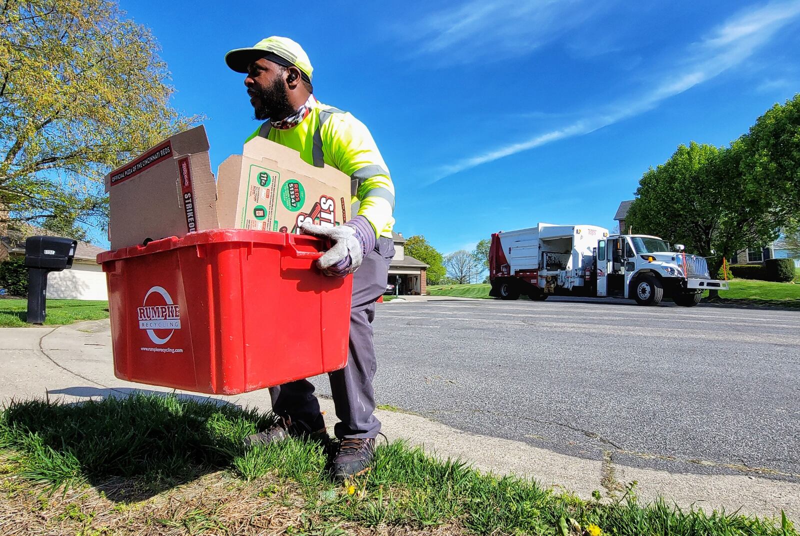Rumpke employee Michael McDonald collects recyclable materials during his route Friday, April 16, 2021 in West Chester Twp. NICK GRAHAM / STAFF