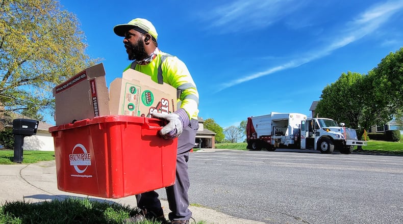 Rumpke employee Michael McDonald collects recyclable materials during his route Friday, April 16, 2021 in West Chester Twp. NICK GRAHAM / STAFF