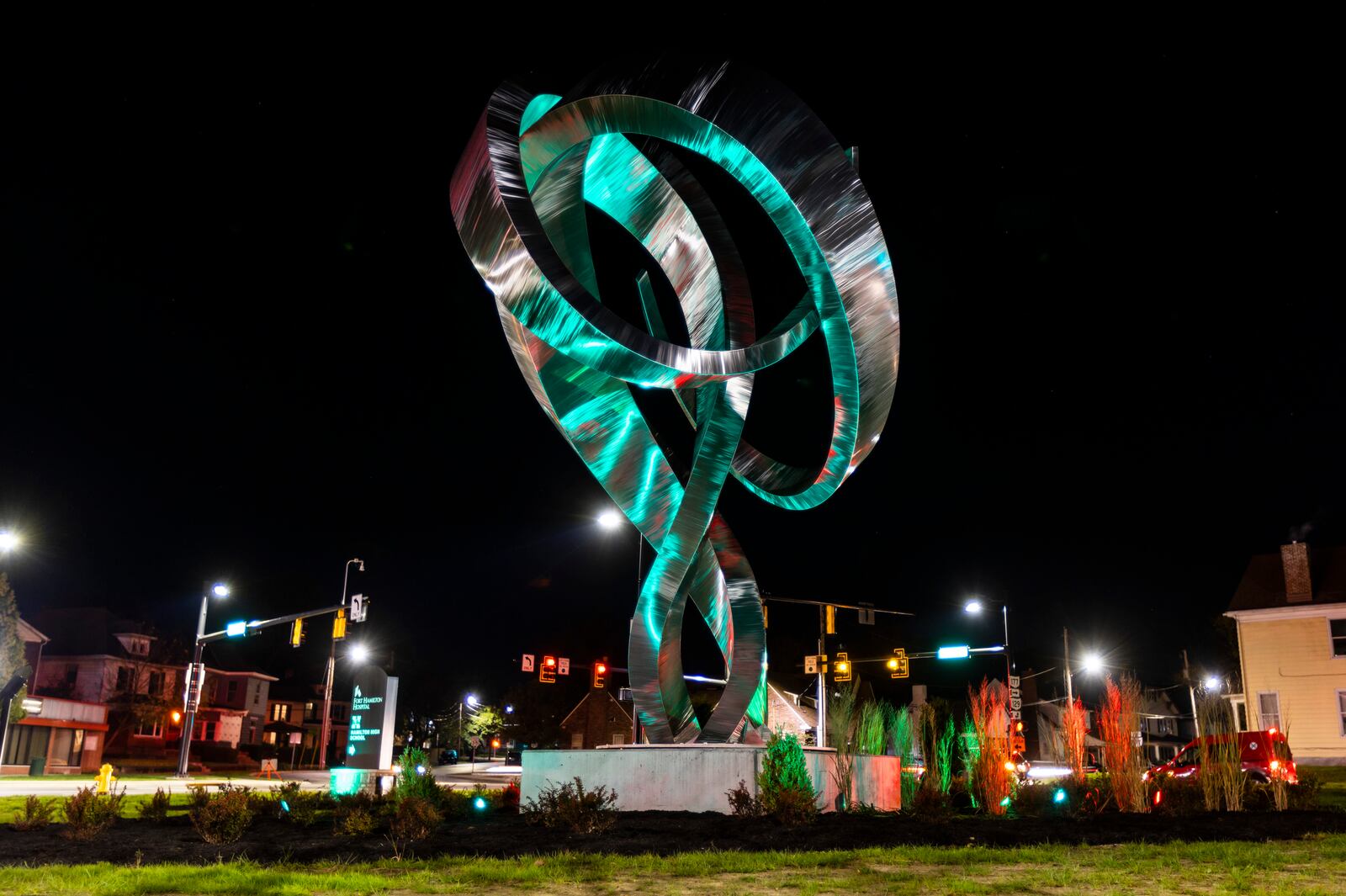 A dedication ceremony was held Wednesday, Nov. 3, 2021 for the 25-foot-tall ‘Embrace’ sculpture, by artist Hunter Brown, which was installed at the newly reconfigured intersection of Main Street with Millville and Eaton avenues in 2020. New lights were installed to illuminate the metal sculpture that can be changed multiple colors. NICK GRAHAM / STAFF