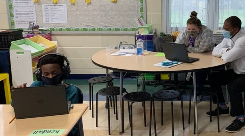 Middletown Schools Superintendent Marlon Styles Jr. (right), visits a classroom. Styles was just awarded a national superintendent of the year honor from a education administrators' group for his leadership during the coronavirus and for closing the "digital divide" among some students in the city schools. (Provided Photo\Journal-News)