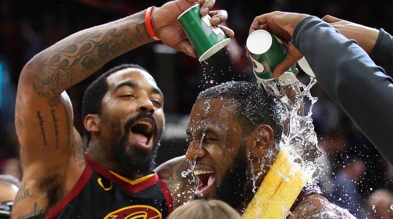 CLEVELAND, OH - APRIL 25: LeBron James #23 of the Cleveland Cavaliers is showered with water by JR Smith #5 while being interviewed after a 98-95 win over the Indiana Pacers in Game Five of the Eastern Conference Quarterfinals during the 2018 NBA Playoffs at Quicken Loans Arena on April 25, 2018 in Cleveland, Ohio. (Photo by Gregory Shamus/Getty Images)