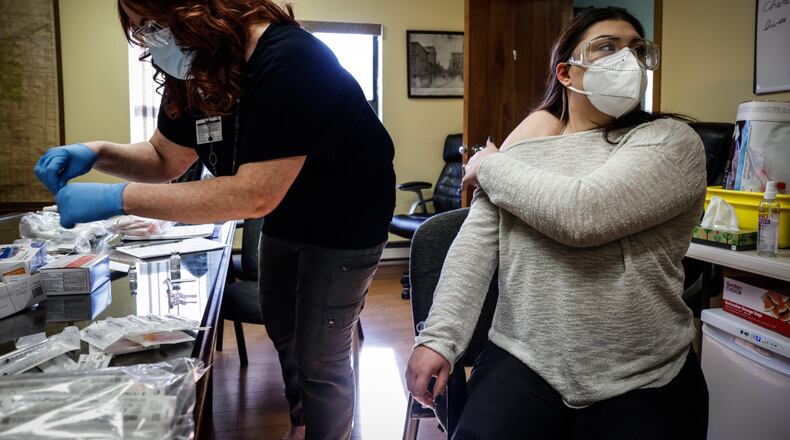 Jacinda Snider, a collaborative pharmacist distributes COVID-19 booster shots at Grafton Oaks Nursing Home on Grafton Ave. Tuesday Jan. 11, 2022. Snider volunteers long hours including evenings and weekends to give people vaccines. She has provided hundreds of Ohioans against COVID-19. JIM NOELKER/STAFF