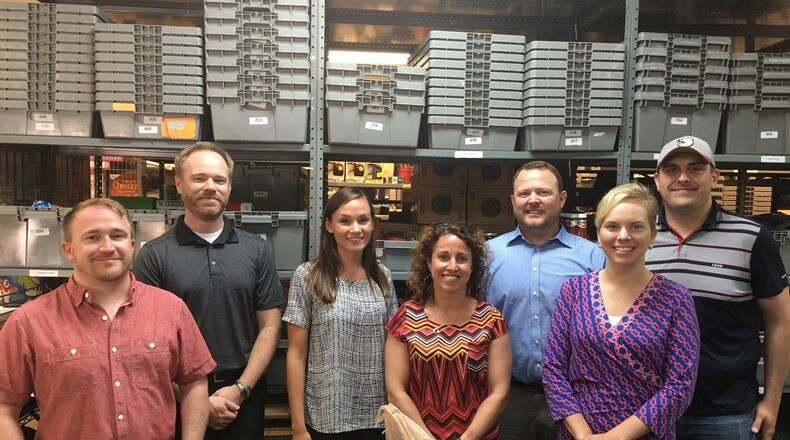 Members of the West Chester-Liberty Chamber Alliance’s NEXT Young Professional’s group inside Reach Out Lakota’s pantry during the inaugural Corporate Food Fight in 2016. CONTRIBUTED