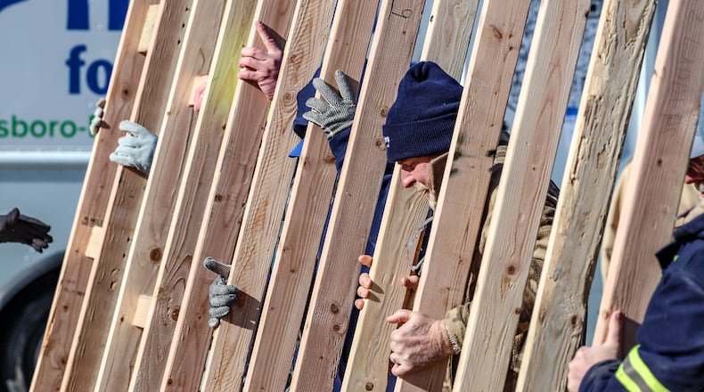 Hamilton will see seven new homes built in the near future by Habitat for Humanity in the Jefferson neighborhood. Pictured is an AP file photo with workers in Kentucky carrying framing studs for a wall of a Habitat for Humanity home in on March 1, 2025, in Owensboro, Ky. (Greg Eans /The Messenger-Inquirer via AP)