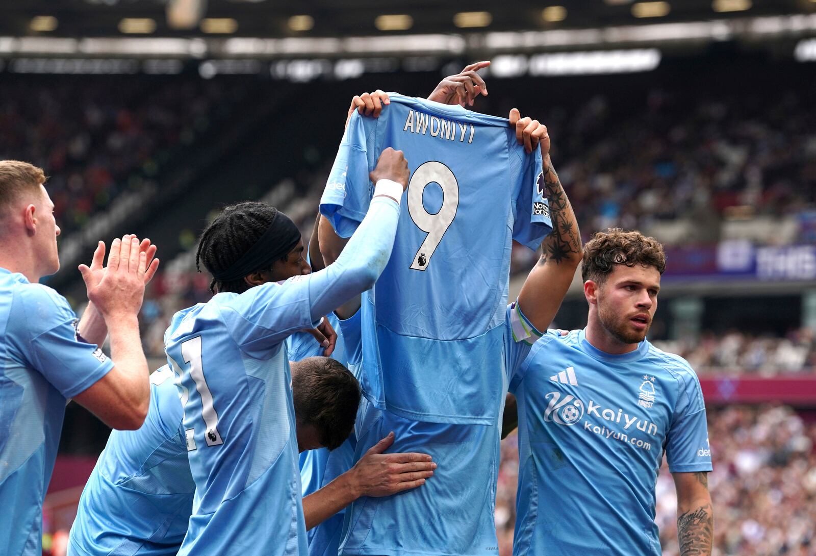 Nottingham Forest's Morgan Gibbs-White celebrates scoring their side's first goal of the game, holding a tribute to teammate Taiwo Awoniyi, during the English Premier League soccer match between Nottingham Forest and West Ham at London Stadium, London, Sunday, May 18, 2025. (Gareth Fuller/PA via AP)