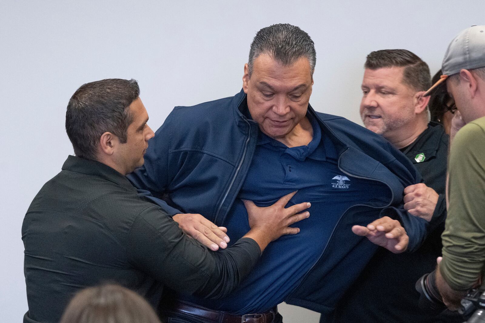 U.S. Sen. Alex Padilla, D-Calif., is pushed out of the room as Homeland Security Secretary Kristi Noem holds a news conference regarding the recent protests in Los Angeles, Thursday, June 12, 2025. (David Crane/The Orange County Register via AP)