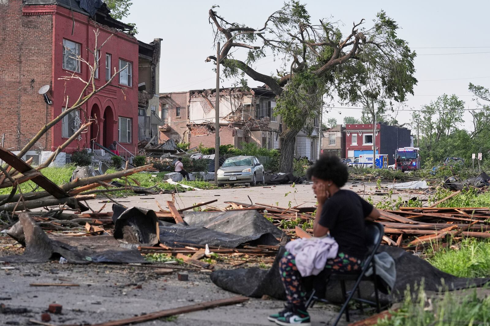 People survey damage after a severe storm moved through Friday, May 16, 2025, in St. Louis. (AP Photo/Jeff Roberson)