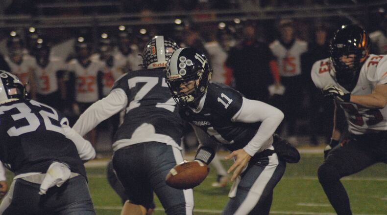 Edgewood quarterback Riley Brown prepares to hand off to Braden Sullivan during Friday night's Division II, Region 8 semifinal vs. Anderson. Chris Vogt/CONTRIBUTED