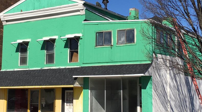 Roofers worked in frigid temperatures on Friday working on top of a building in the 1300 block of Central Avenue. This is one of several buildings that businessman Todd Fisher has purchased and is renovating in downtown Middletown. Fisher is seeking a Community Reinvestment Act tax abatement on several properties. He is investing a total of $200,000 to update and improve the street-level businesses and upper level apartments. ED RICHTER/STAFF
